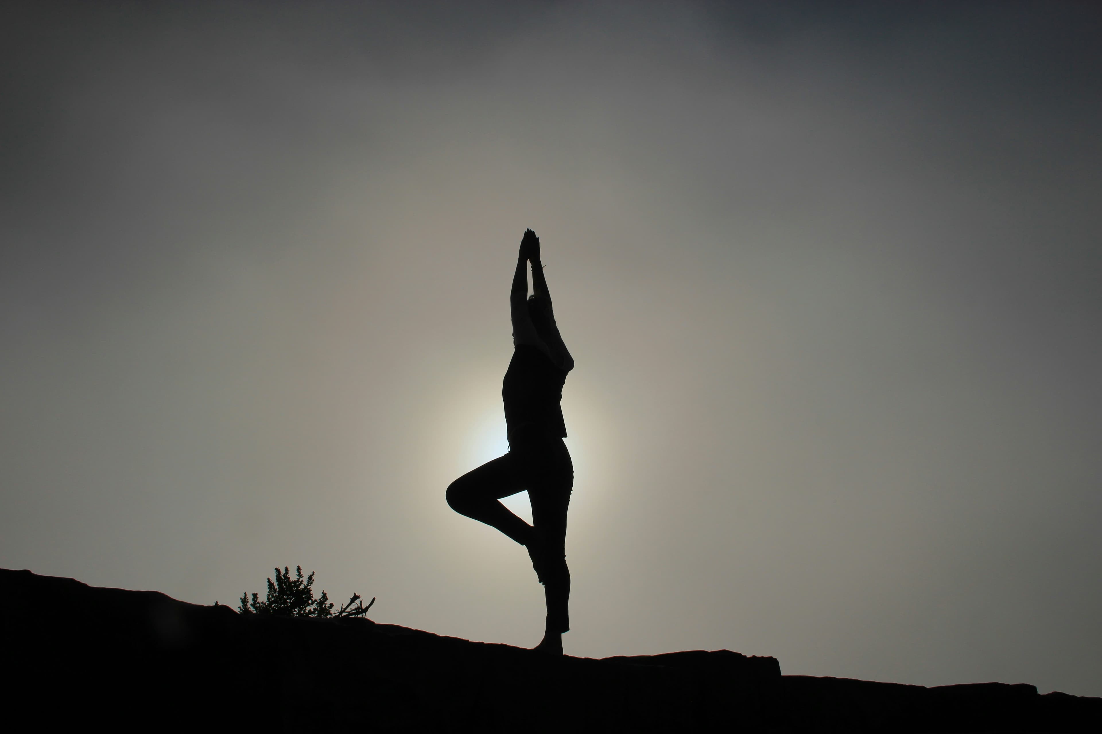 Beginner practicing a simple yoga pose on a mat at home