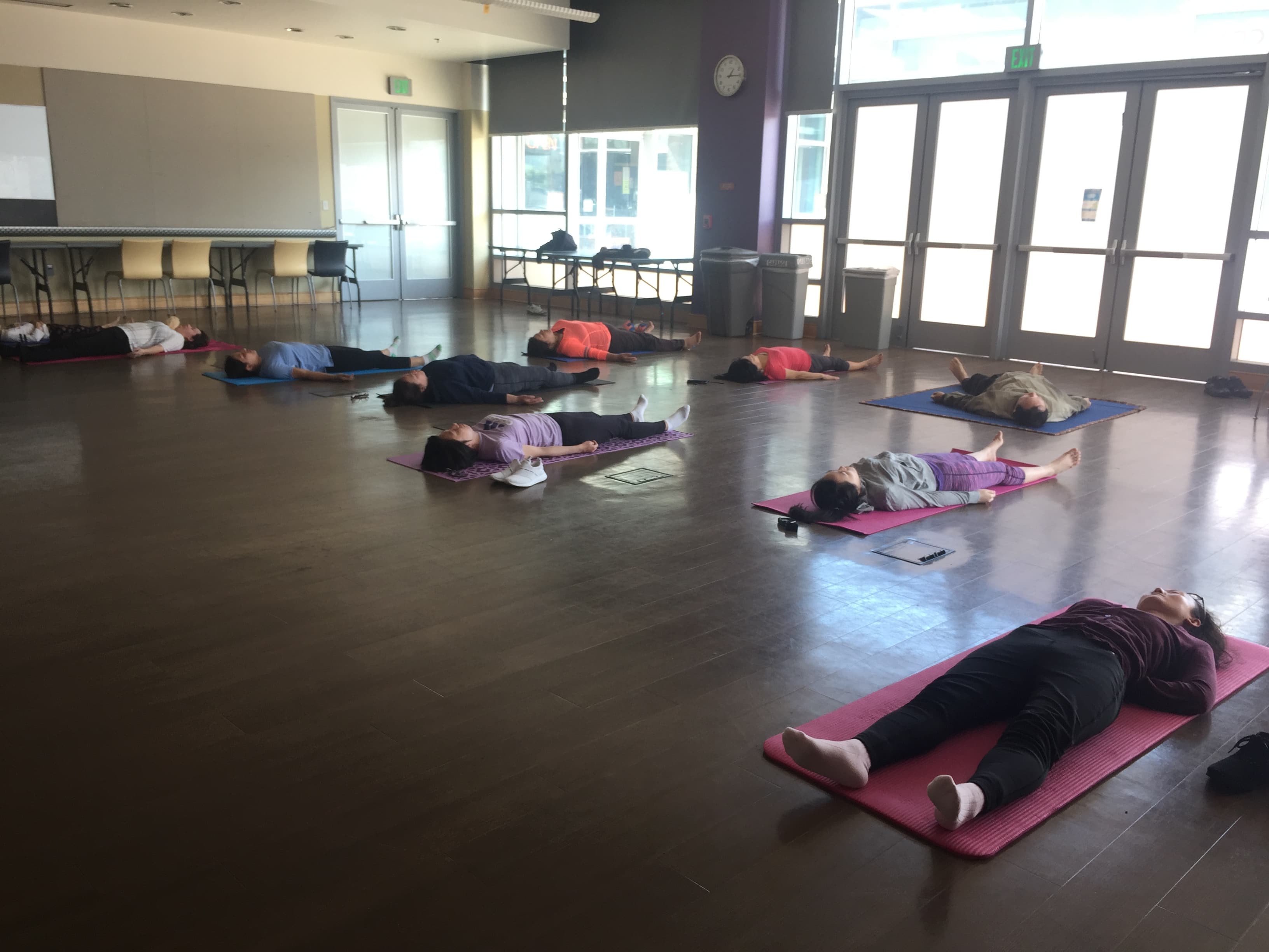 Group yoga class in a bright open community space